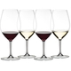 Four RIEDEL Wine Friendly RIEDEL 001 - Magnum glasses alternately filled with red wine and white wine, stand slightly offset next to each other.