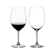 Two RIEDEL Vinum Bordeaux Grand Cru glasses on white background. The one on the left side is filled with red wine, the other one is empty.