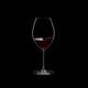 RIEDEL Veritas Old World Syrah filled with a drink on a black background
