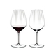 Two RIEDEL Performance Cabernet glasses side by side. The glass on the left side is filled with red wine, the other one is empty.
