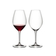 Two RIEDEL Wine Friendly Red Wine glasses side by side against a white background. The glass on the left side is filled with red wine, the glass on the right side is empty.