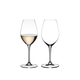 Two RIEDEL Wine Friendly White Wine / Champagne Wine Glasses side by side against a white background. The glass on the left side is filled with white wine, the glass on the right side is empty.