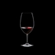 RIEDEL Restaurant Syrah filled with a drink on a black background