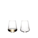 Two SL RIEDEL Stemless Wings Riesling / Champagne Glasses side by side on a white background. The glass on the right side is filled with champagne, the other one is empty.