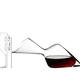 Woman sits on a table with a red wine filled RIEDEL Winwings Cabernet glass and a RIEDEL Altitude Matters Decanter.