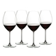 Four red wine filled RIEDEL Veritas Old World Syrah glasses stand slightly offset next to each other