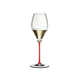 A RIEDEL Fatto A Mano Performance Champagne Glass with a red stem and filled with champagne