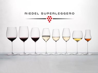 RIEDEL Superleggero Machine Made Collection filled with wine on a grey backdrop with the logo above.