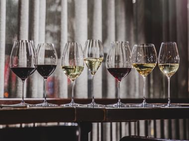 RIEDEL Performance collection on a table top filled with wines.