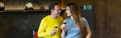 two people holding espresso glasses