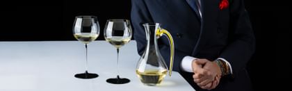 RIEDEL Fatto a Mano Cabernet Decanter next to two Fatto a Mano Black Tie glasses