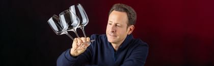 Maximilian J. Riedel holding 3 GRAPE@RIEDEL glasses