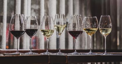 RIEDEL Performance collection on a table top filled with wines.