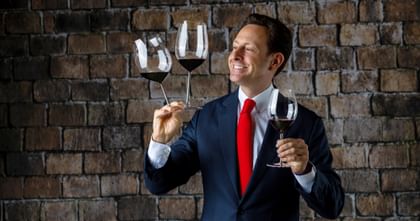 Maximilian J. Riedel holding three Sommeliers glasses