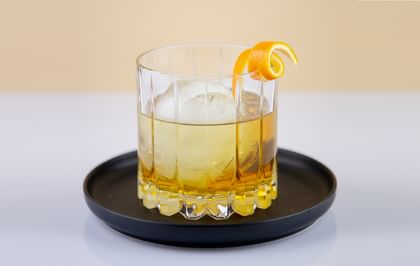 whisky cocktail on black plate