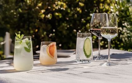 SPIEGELAU Capri long drink glass, tumbler, white wine glass and red wine glass on a table in the garden