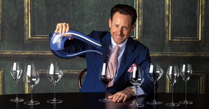 Maximilian J. Riedel pouring wine from decanter 