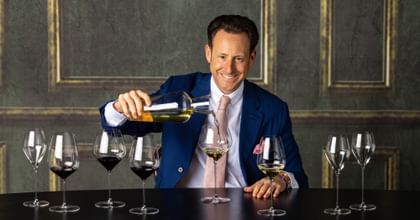 Maximilian J. Riedel and a row of glasses
