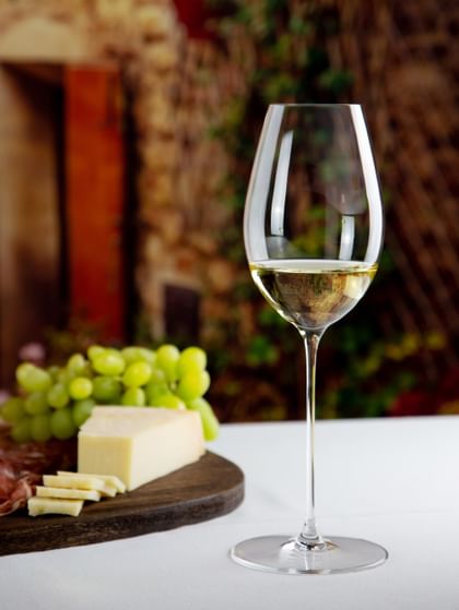 white wine glass next to food on table