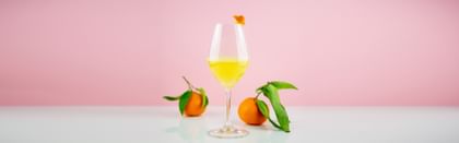 cocktail in RIEDEL glass beside oranges