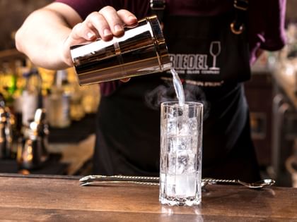 bartender showcasing cocktail in RIEDEL glass