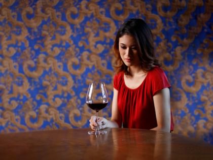 woman holding red wine glass