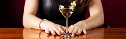 up close two hands holding the base of a cocktail in RIEDEL Drink Specific Glassware