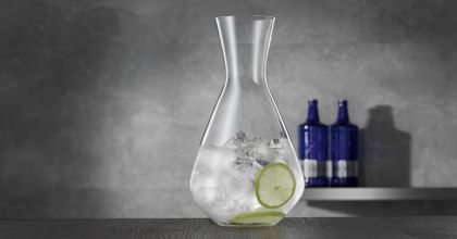 carafe with lime flavored water on table