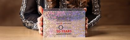 woman holding a 20 Year Anniversary labeled Riedel packaging box