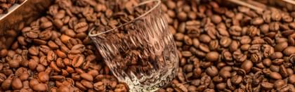 coffee glass laying in coffee beans