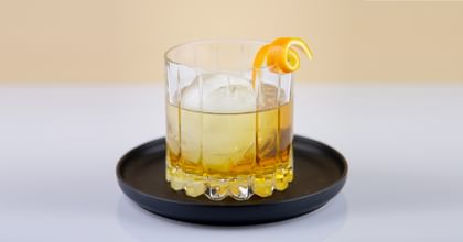 whisky cocktail on black plate