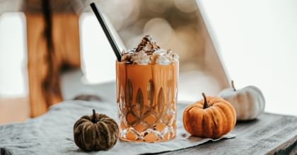 cocktail in RIEDEL Laudon glass surrounded by pumpkins