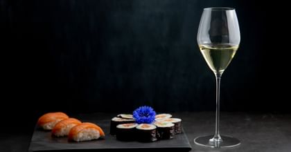 glass of sauvignon blanc next to sushi