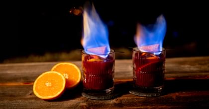 Fire Tongs Punch Cocktail in a Riedel Shadows Glass