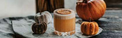 cocktail next to pumpkins