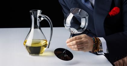 RIEDEL Fatto a Mano Black Tie glass next to RIEDEL Fatto a Mano Cabernet Decanter