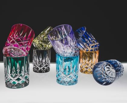 RIEDEL Laudon Collection lined up on a bench with a black background.