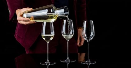 Three RIEDEL Superleggero Champagne Wine Glasses filled with Champagne.