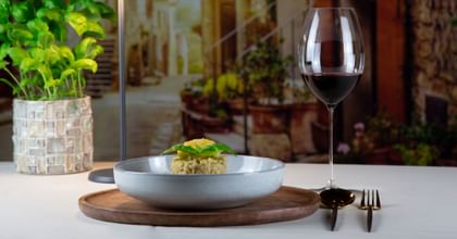 red wine glass next to dumpling dish
