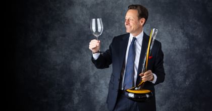 holding RIEDEL wine glass and Cobra Decanter