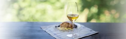 white wine glass next to food outdoors