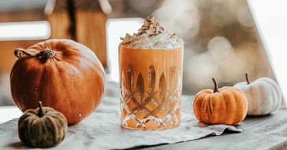 cocktail in RIEDEL Laudon glass surrounded by pumpkins