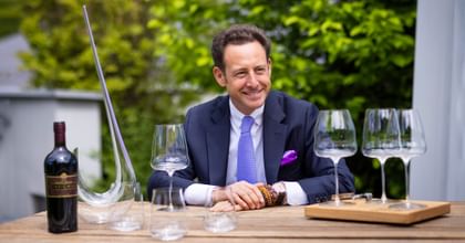 Maximilian J. Riedel outside with multiple RIEDEL wine glasses