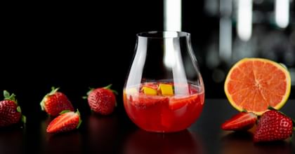 cocktail surrounded by strawberries