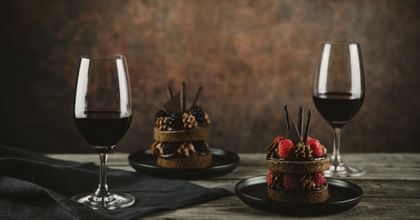 red wine glasses in front of desserts