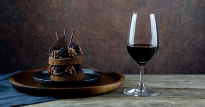 red wine glass in front of dessert
