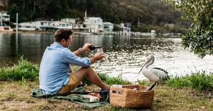 Man enjoying a picnic near lake