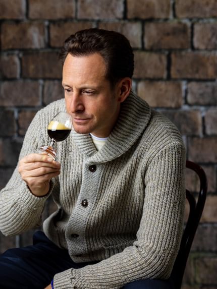 man holding Nespresso glass
