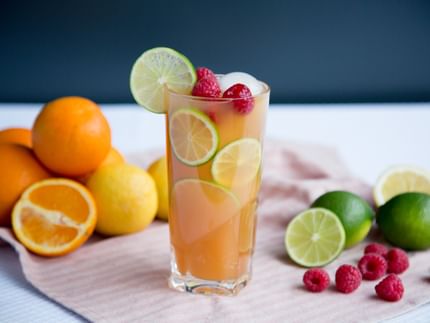 orange beverage with limes
