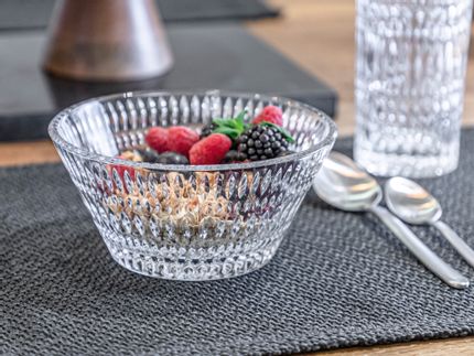 The NACHTMANN Ethno bowl filled with cereals and berries on a table mat. Next to it are two spoons, in the background is an Ethno longdrink glass.<br/>